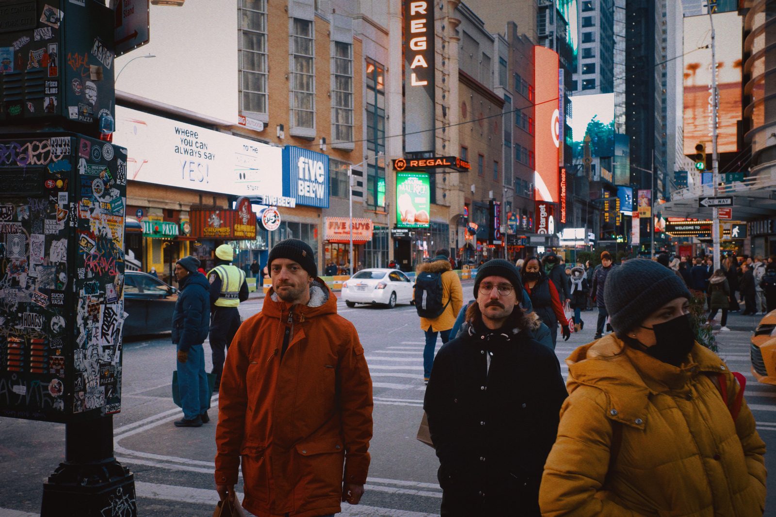 People in winter coats on a night street — New York