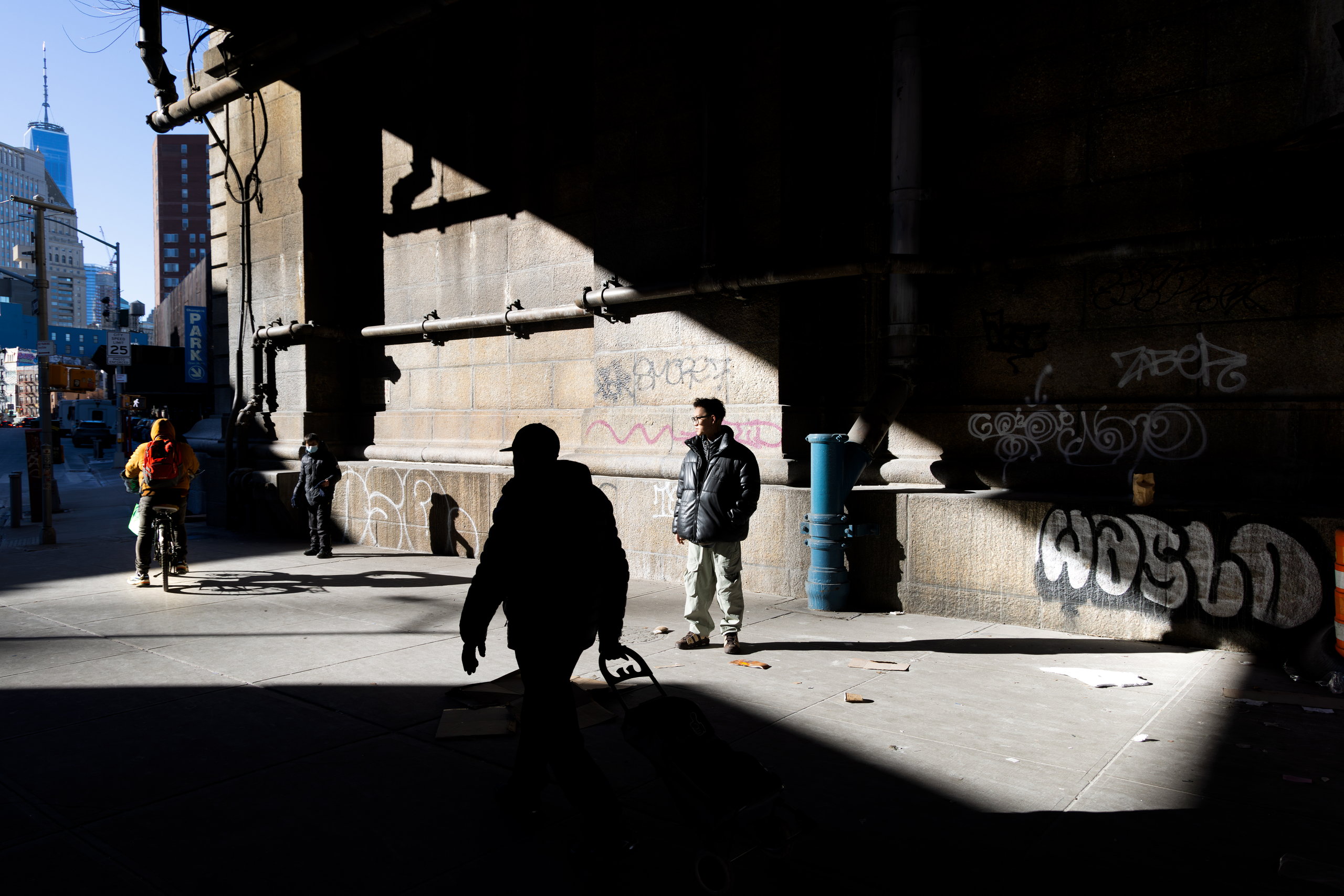 Figures in hard light beneath an elevated railway — Win or Lose
