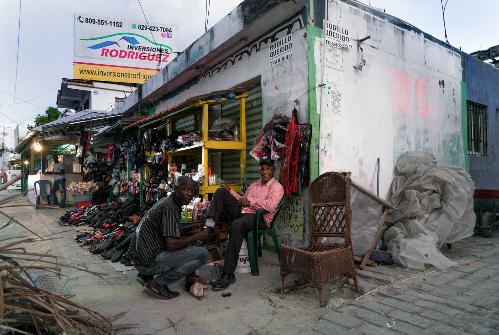 A street piled with motorcycles and goods outside small shops — Punta Cana