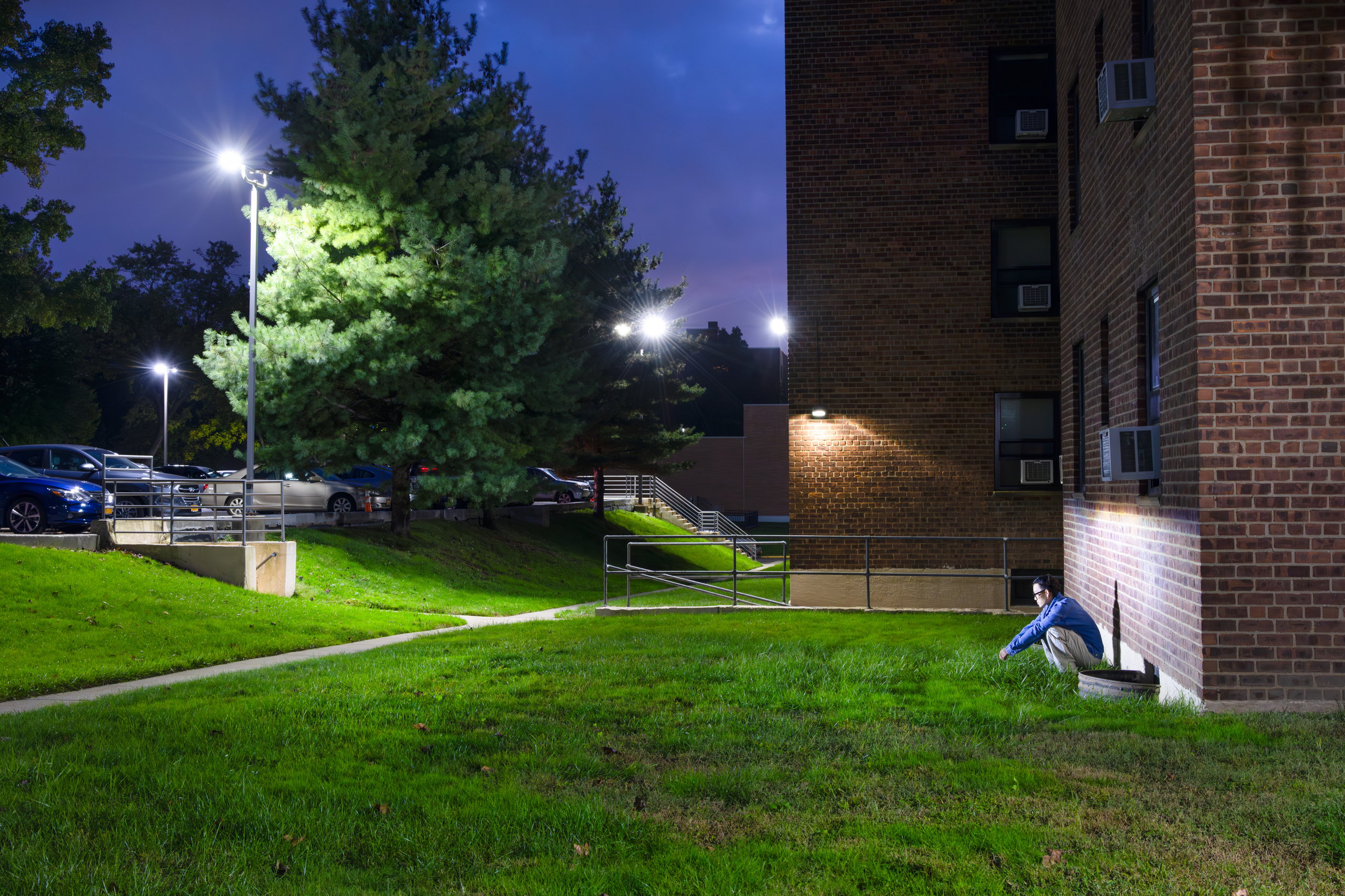 A lawn and apartment building at night, under a streetlight — Win or Lose